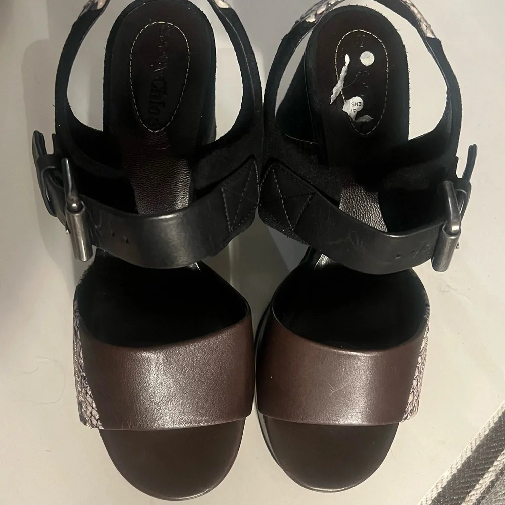 See by Chloe . Black , brown and python print platform heels.